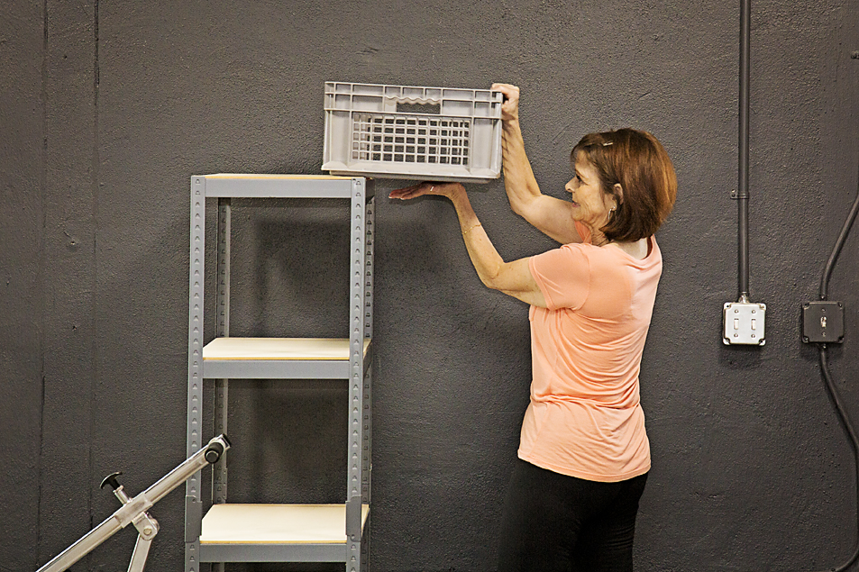 Patient lifting box onto shelf