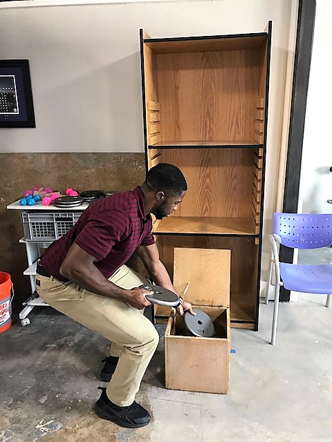 Patient putting weights in box